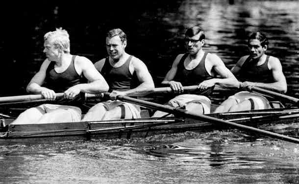 A black-and-white photograph of Bob and his crewmates rowing a four. 