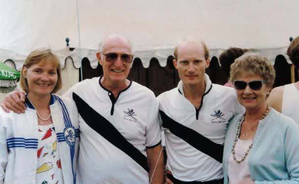 Two men in Manila Boat Club gear, flanked by two women, not in Manila Boat Club gear.
