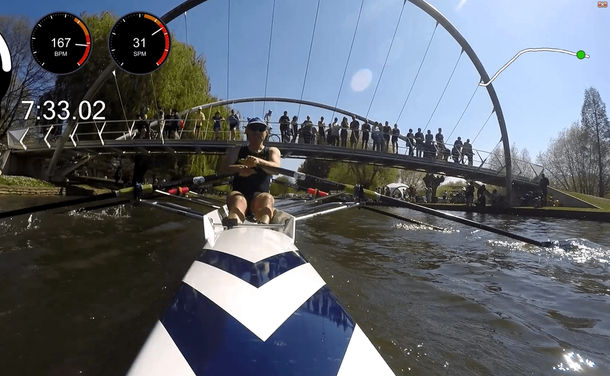 An on-board photo from the stern of our victorious single scull, showing a spectator-packed bridge and a onscreen speed display of 8.88 mph. 