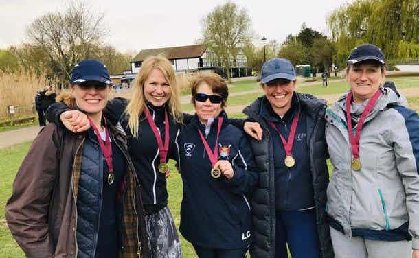 The four victorious ladies of the women’s masters D coxed quad smiling with their medals. 
