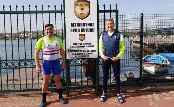 Andrew Blit and Kayhan Yalçın posing for a photo in front of a Turkish rowing club.